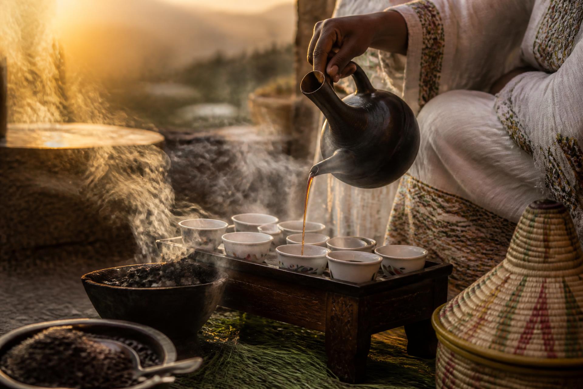 Ethiopian coffee ceremony with a jebena pouring coffee at golden hour